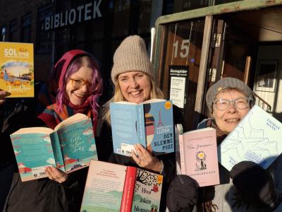 Viser 3 forfrosne biblioteksværter med bøger i hænderne