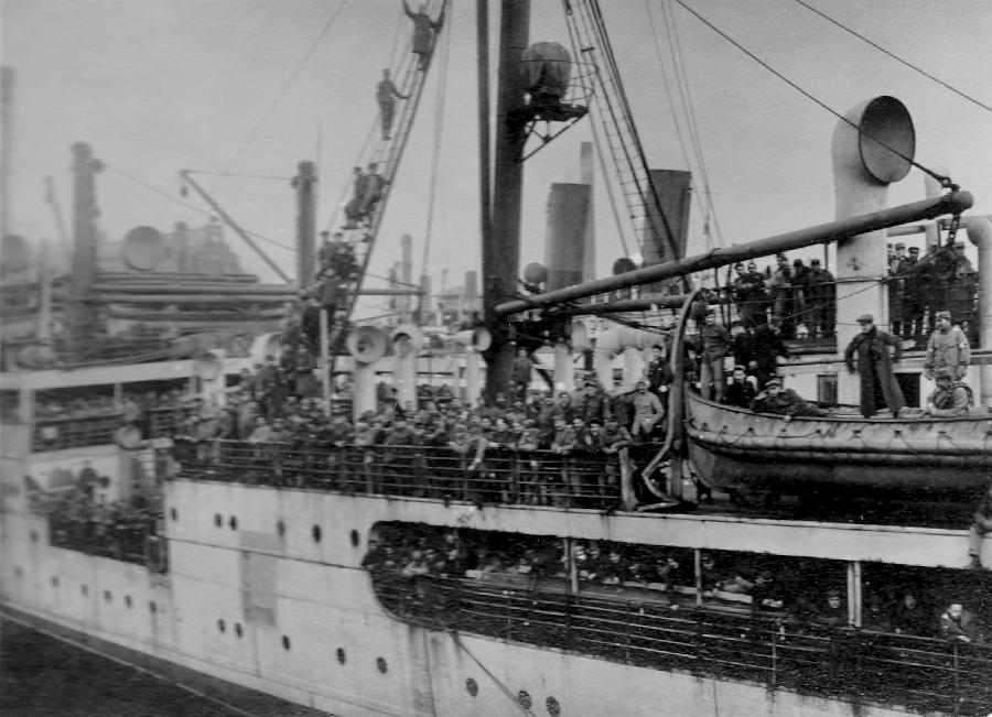 Sort hvid foto af skib med soldater ombord.